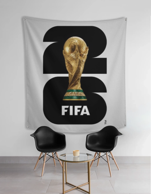 FIFA World Cup tapestry with trophy design in a room with two black chairs and a small table.