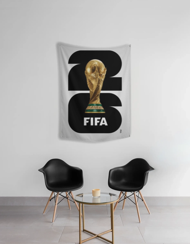 FIFA World Cup tapestry with trophy design in a room with black chairs and a small table.