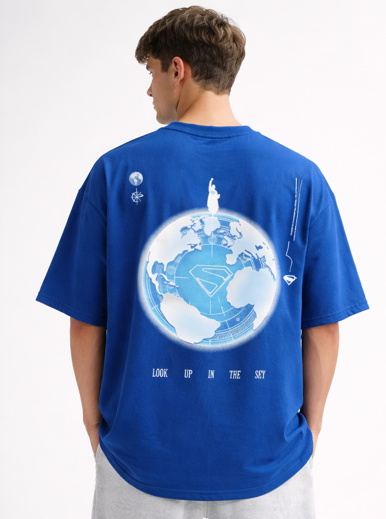Person wearing a blue t-shirt with a graphic design on the back, standing against a white background
